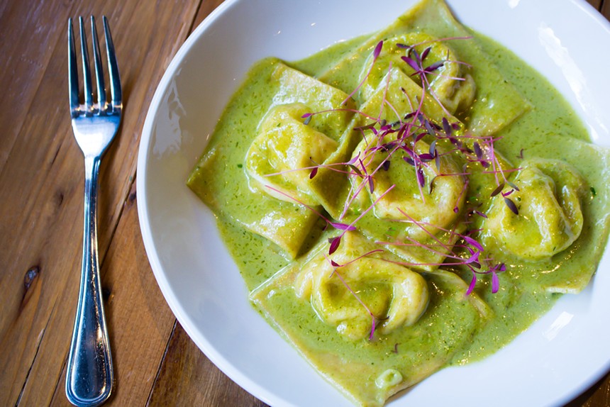 ravioli on a plate with green sauce
