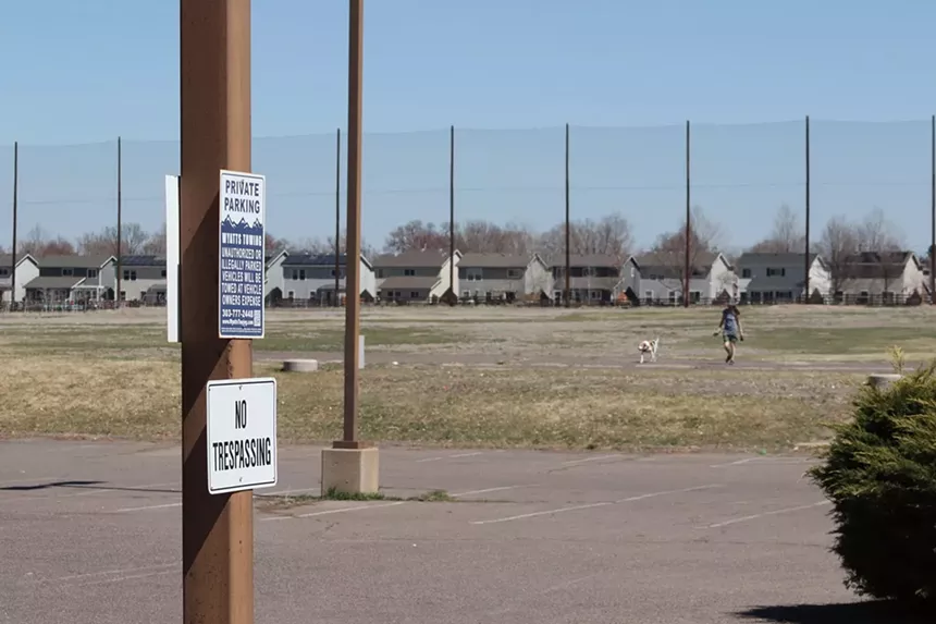 A no trespassing sign and large fence block access to a defunct golf course.