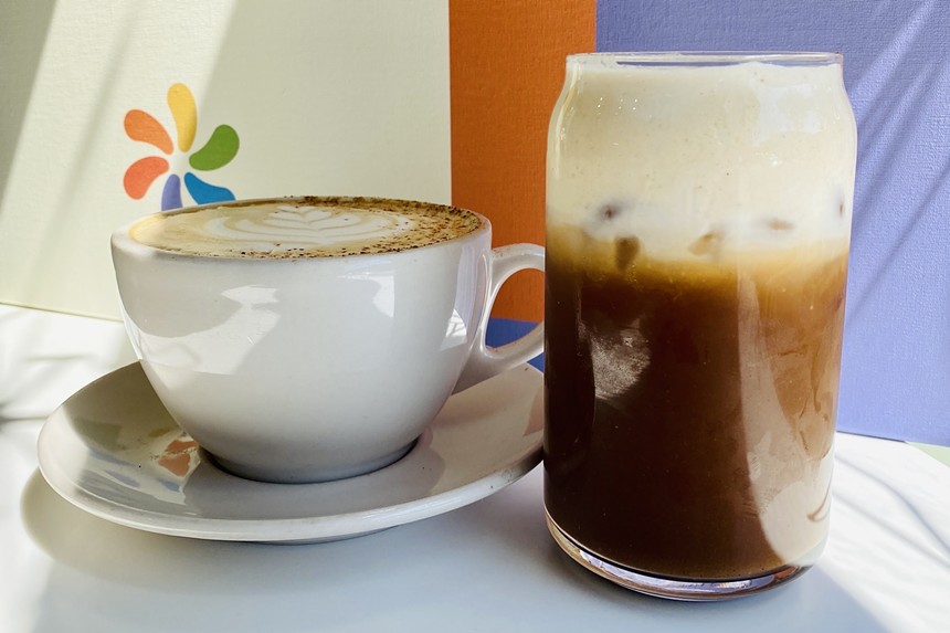 a mug of coffe and a cold coffee drink in a glass