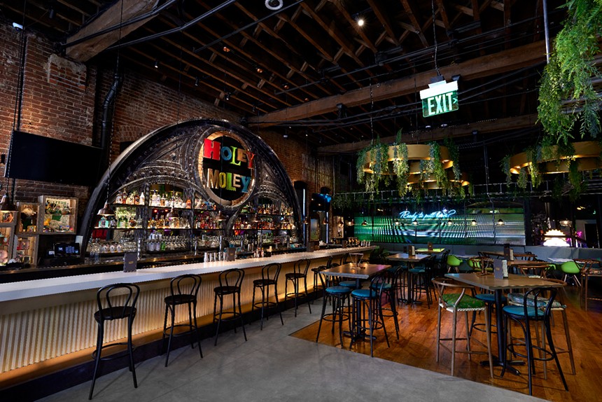 a stocked bar with empty seats