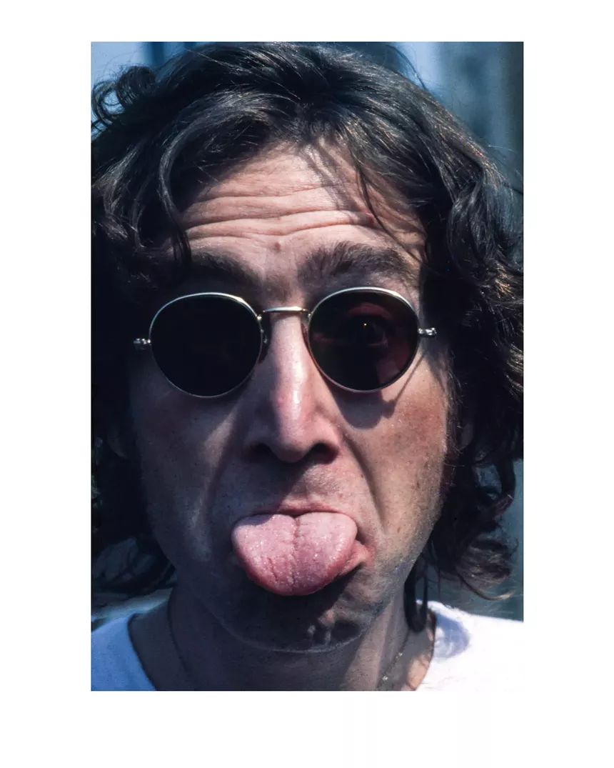 man in black sunglasses sticking his tongue out