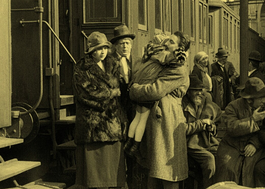old-time photo shows family dressed up about to get on a train