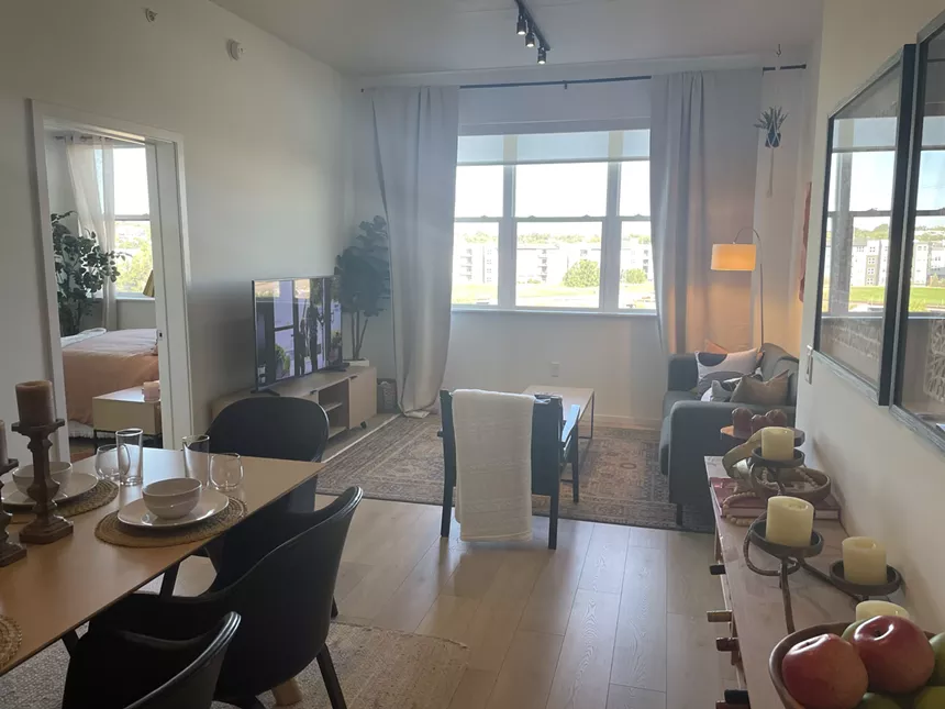 A room with a dining and living space.