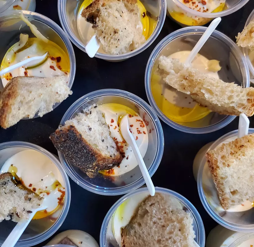 small cups of hummus with bread