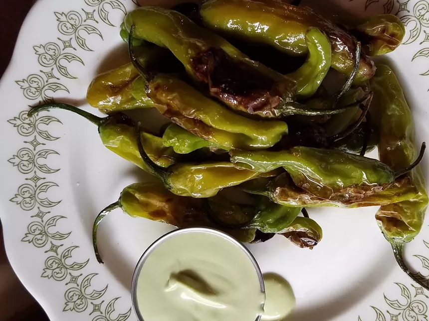 white plate with green peppers on it