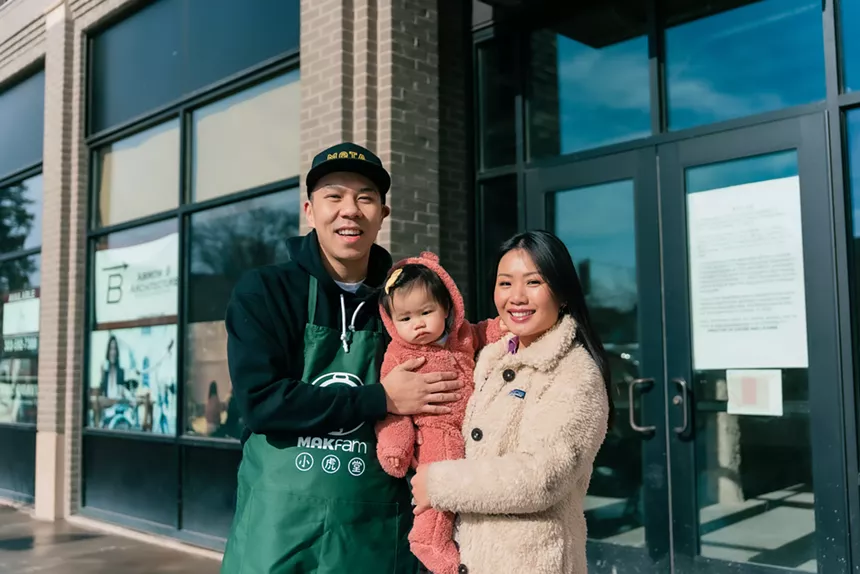 a man and a woman holding a young child