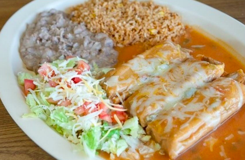 plate of mexican food smothered in green chile