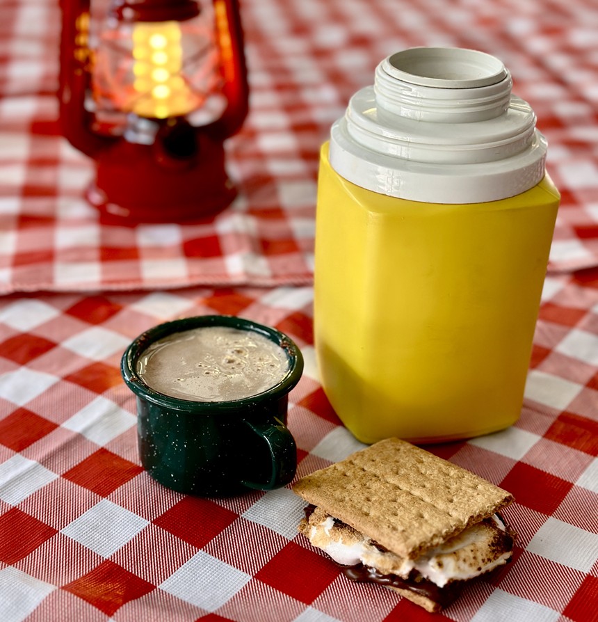 a s'more, a yellow thermo and a drink in a cup