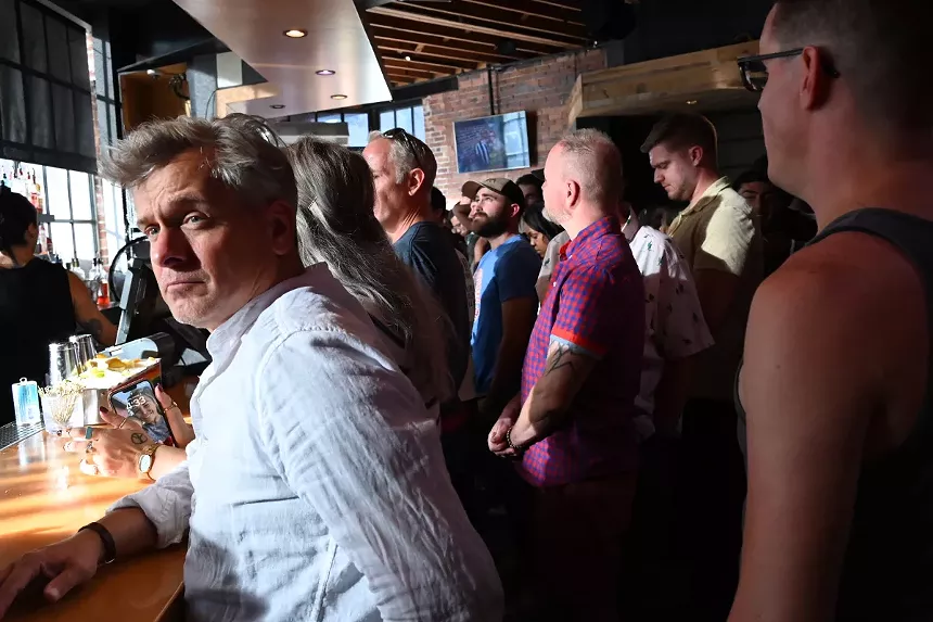 People wait to order from the bar at the Triangle during its "Farewell Beer Bust."