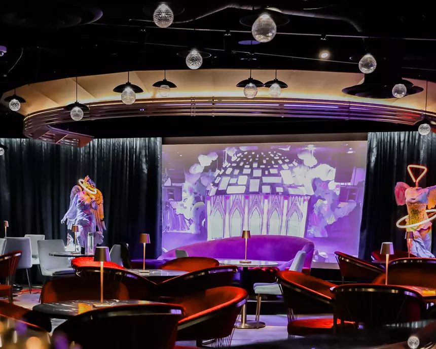 a projection screen in a lounge