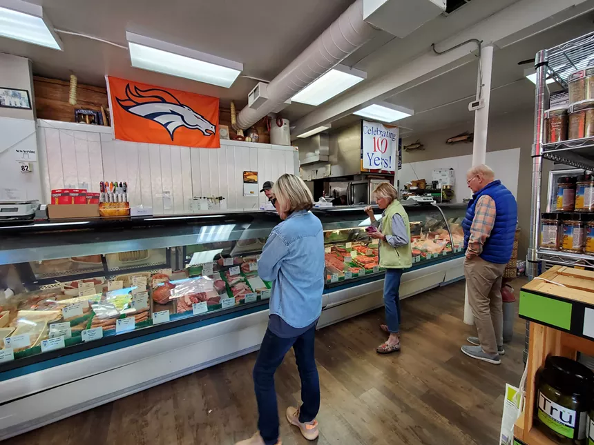 people standing in a butcher shop
