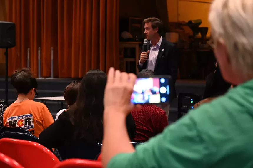 Mayor Mike Johnston speaks during a community information meeting.