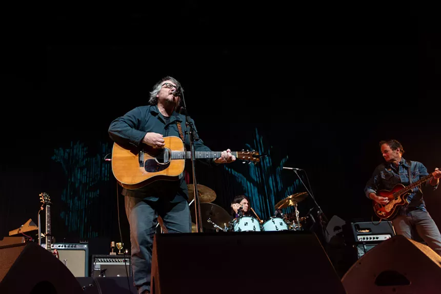 man playing acoustic guitar on stage