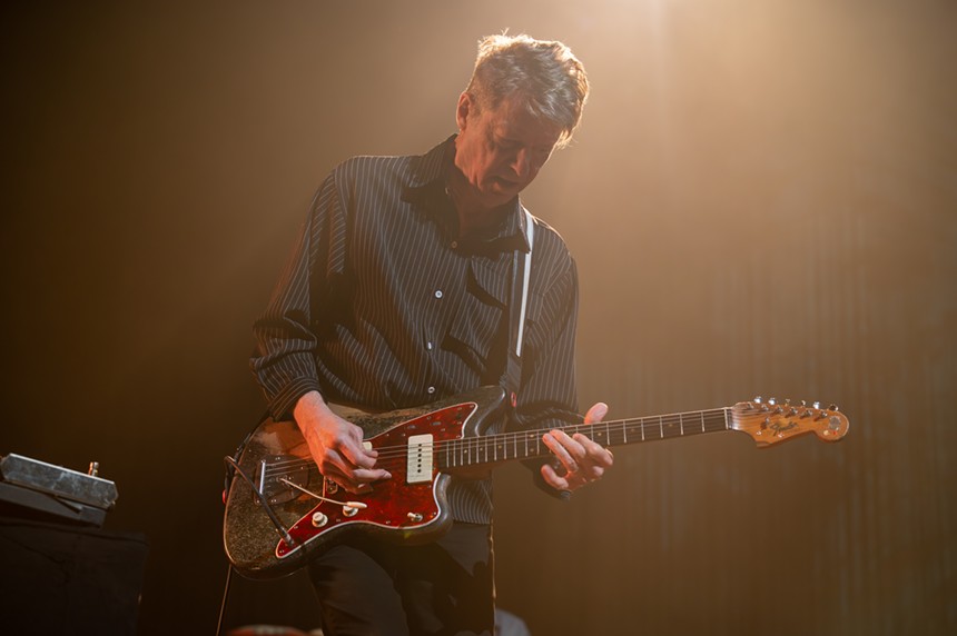 man playing electric guitar on stage
