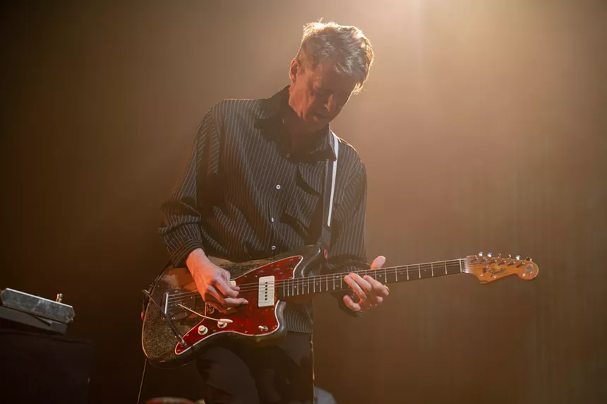 man playing electric guitar on stage
