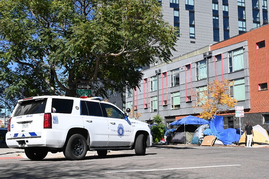 Denver Police move a few homeless residents out of public right-of-ways.