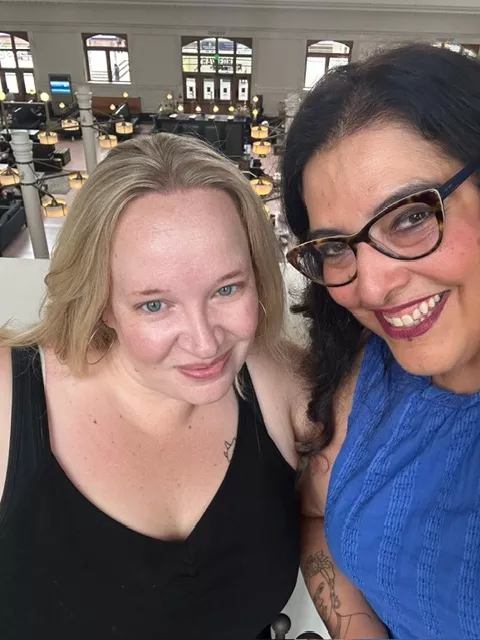 two women posting for a selfie
