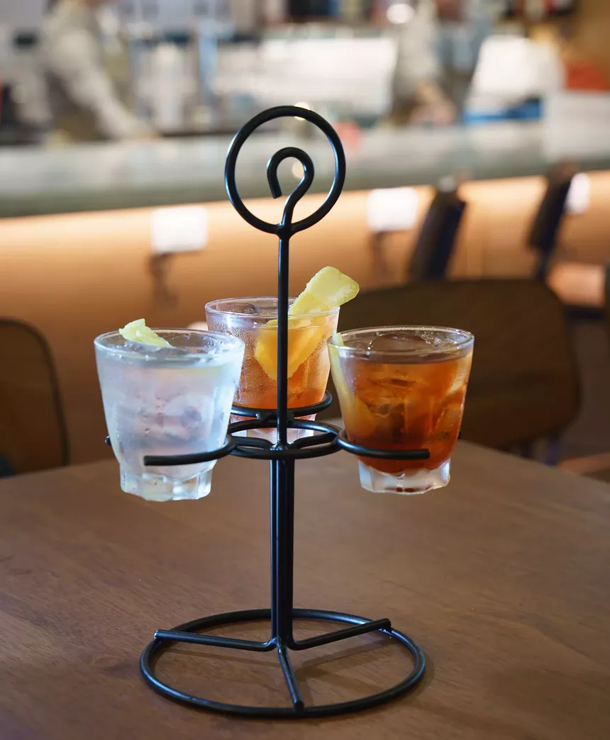 three cocktails in a holder