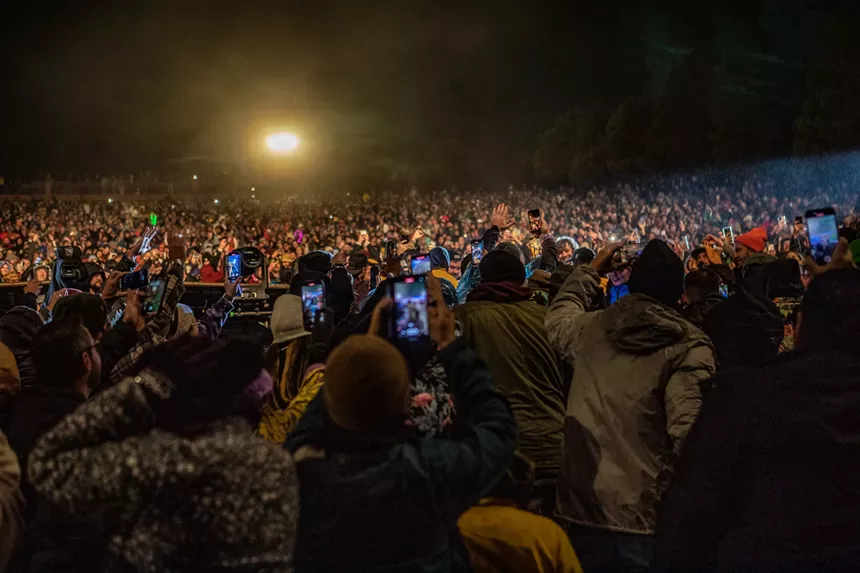 crowd of people holding up their phones