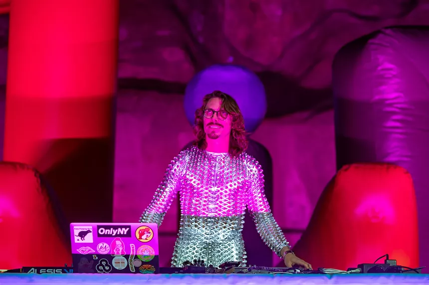 man in silver suit deejaying