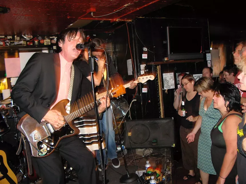 a man on a stage with a guitar