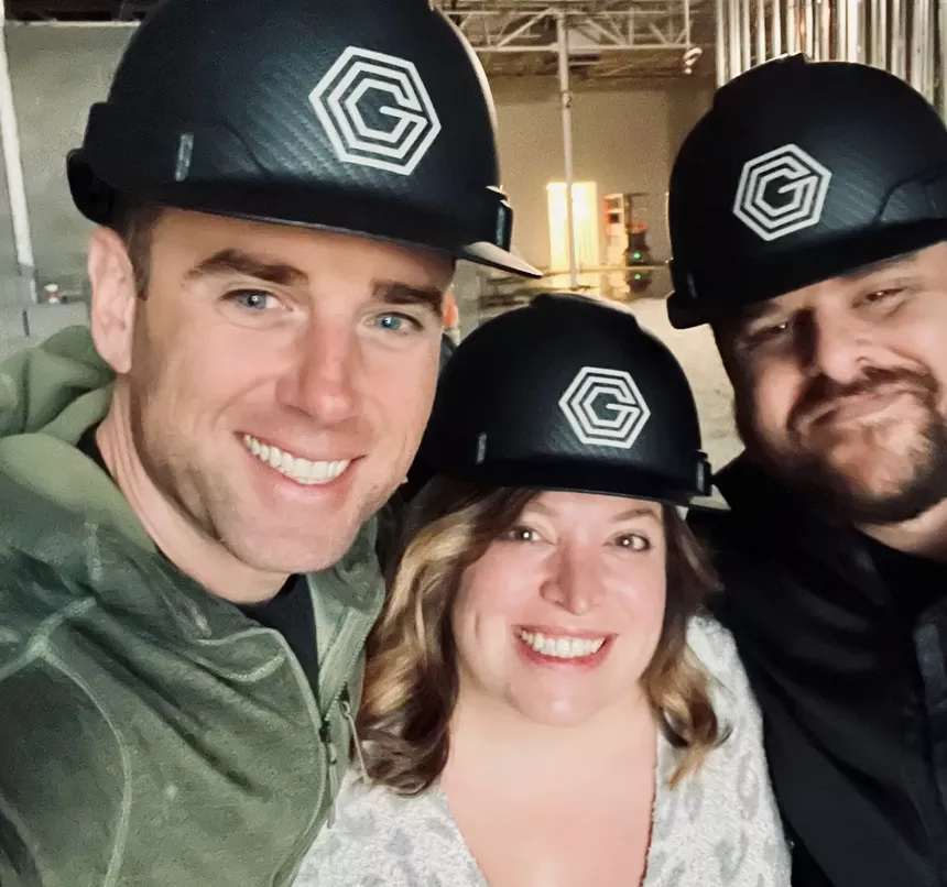 three people in hard hats