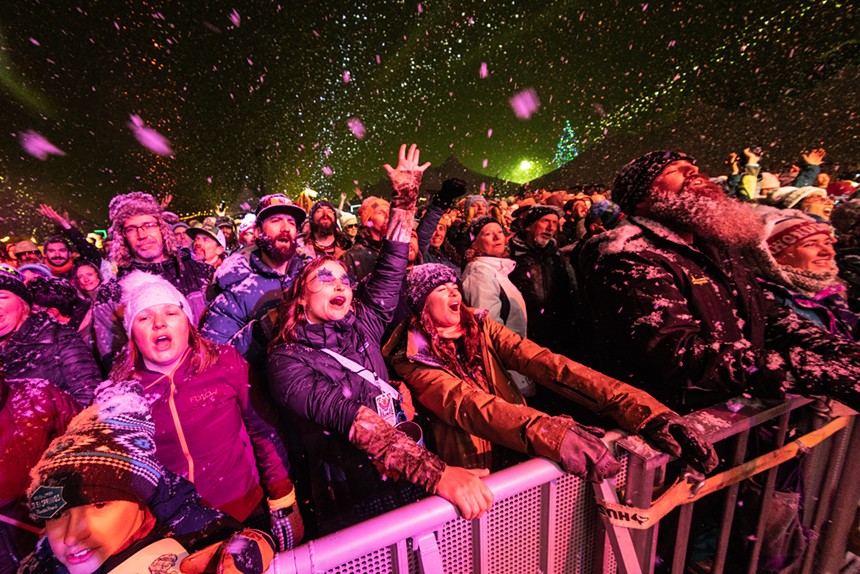 a concert audience dancing in the snow