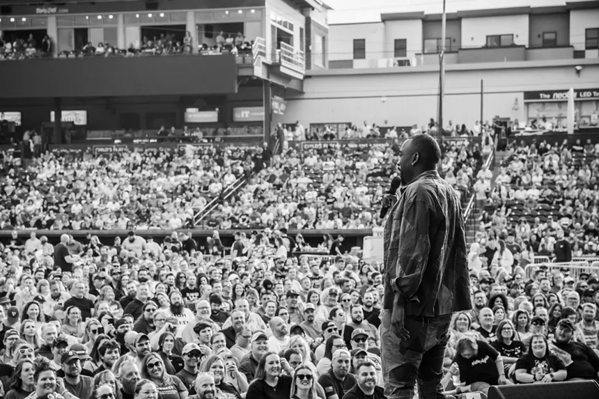 standup comedian speaking to a big audience
