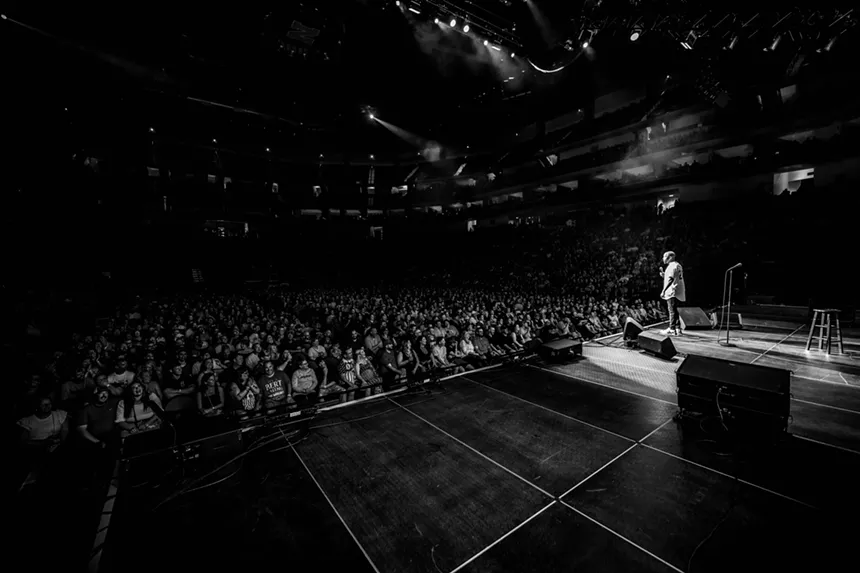 standup comedian speaking to a big audience