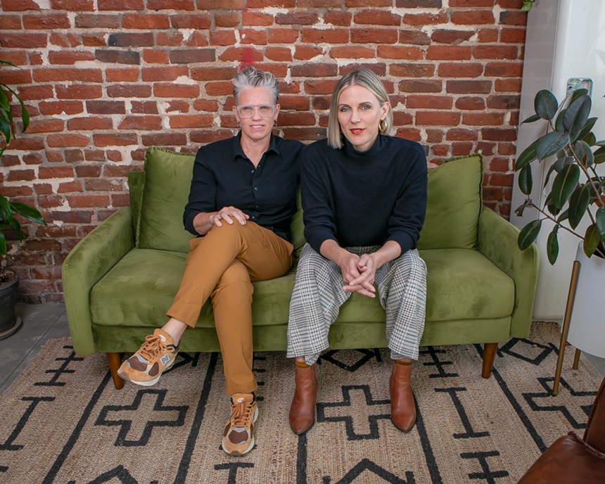 two people sitting on a green couch