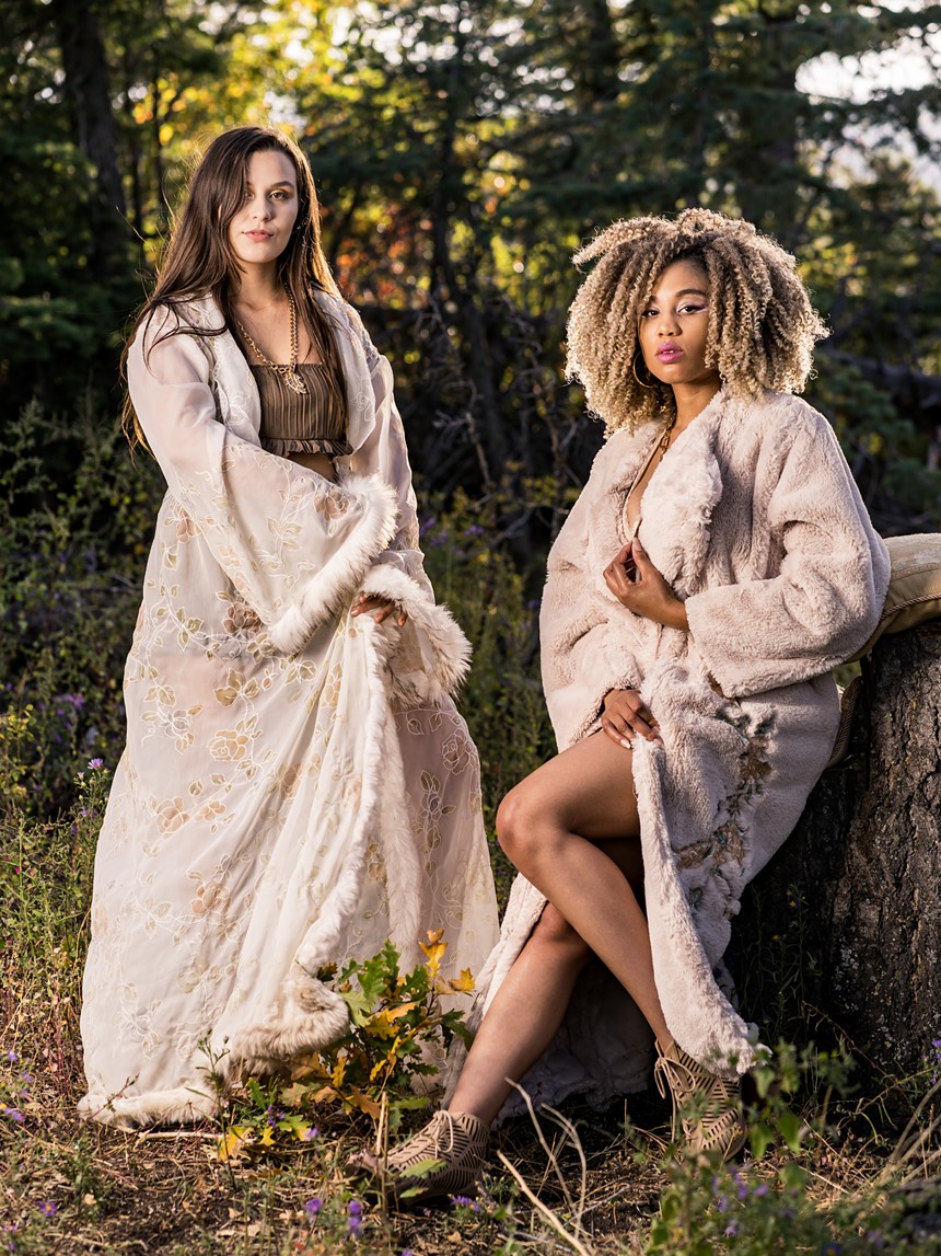two women posing wearing cream-colored layer designs