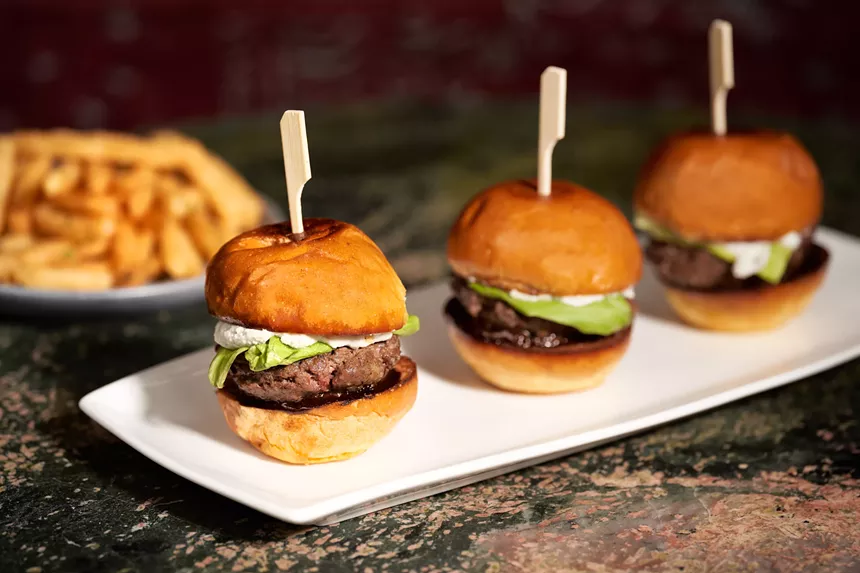 white plate with three small burgers on it