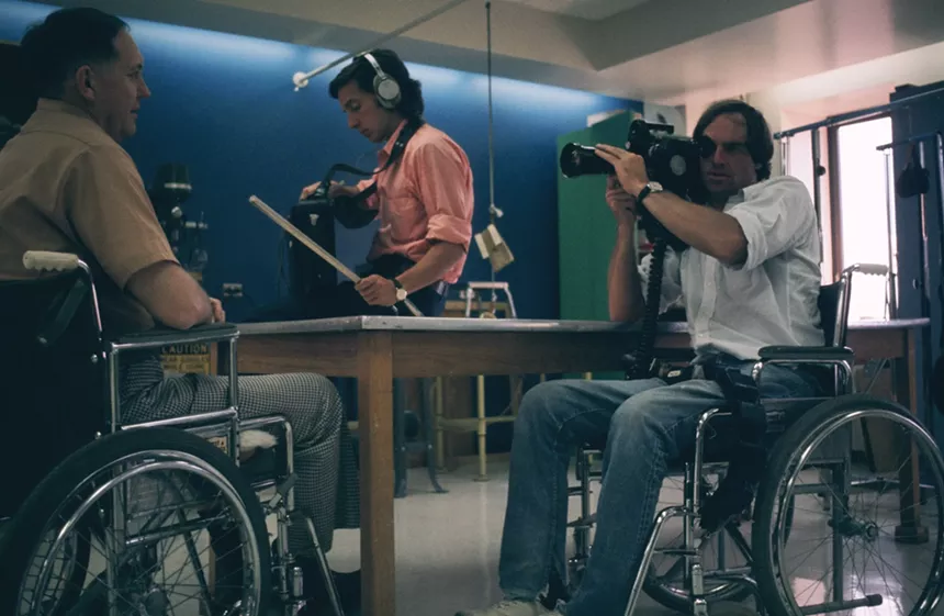 Man in wheelchair filming.