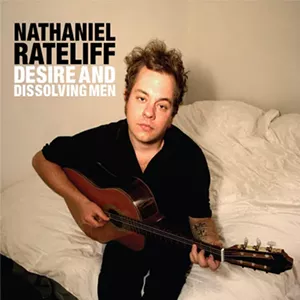 man holding an acoustic guitar looks into camera, the words "Nathaniel Rateliff Desire and Dissolving Men" are next to his head.