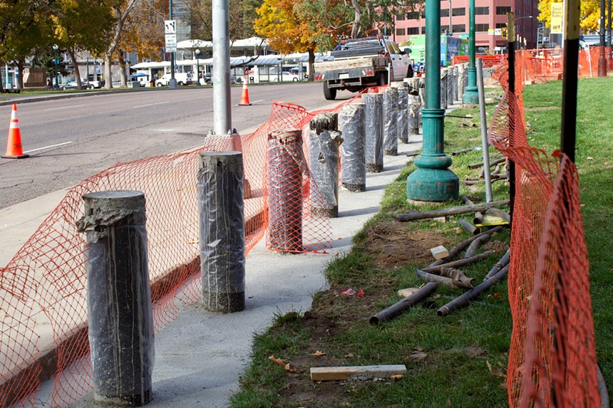 Metal posts encased in cement line the lawn of the Colorado Capitol Building.