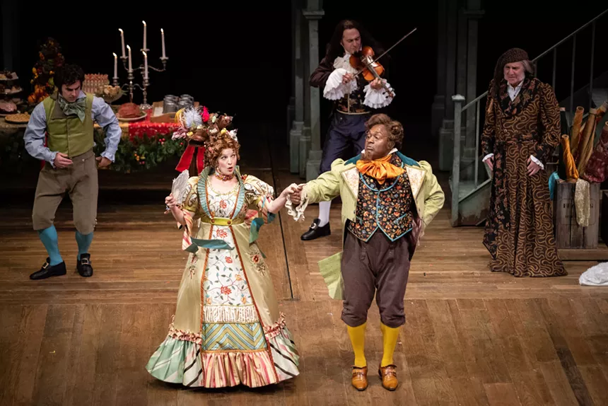 A Christmas Carol actors on stage.