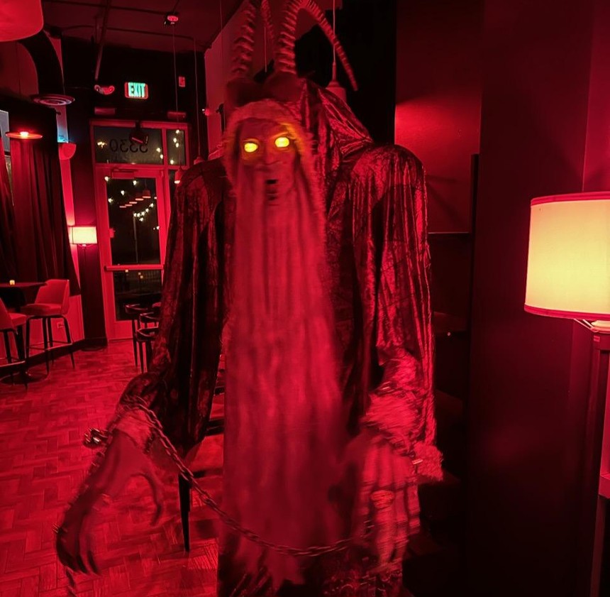 a demonic figure in a red room