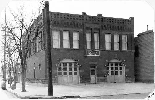 black and white photo of an old brick firehouse