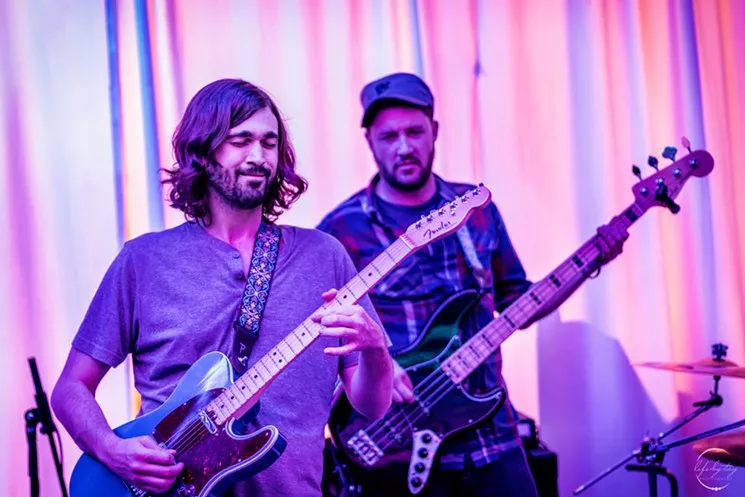 Zack Smith playing guitar with his band Autonomix.