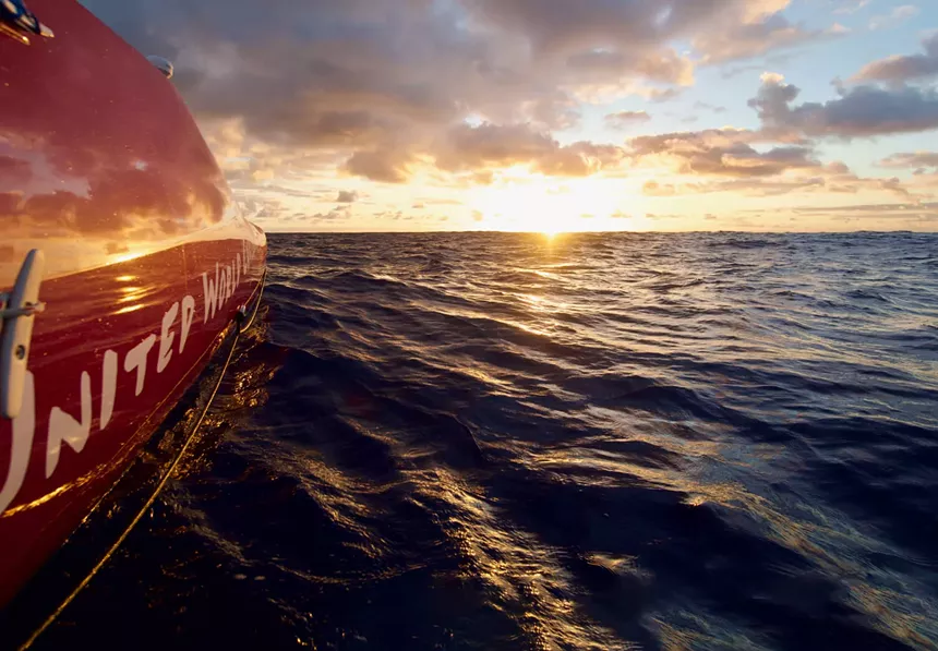 boat on ocean at sunset