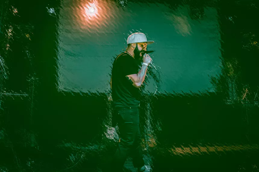 man rapping in white hat