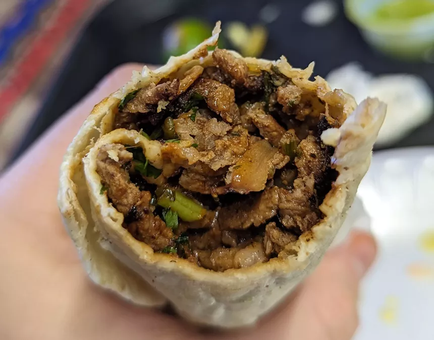 inside of a taco filled with meat