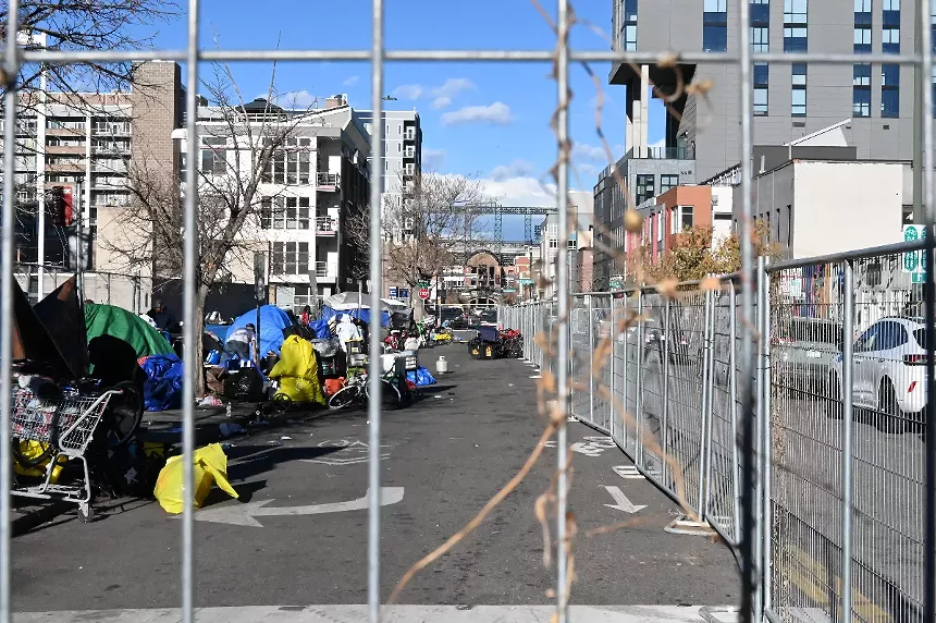Fencing went up around the Ballpark District encampment for a sweep.