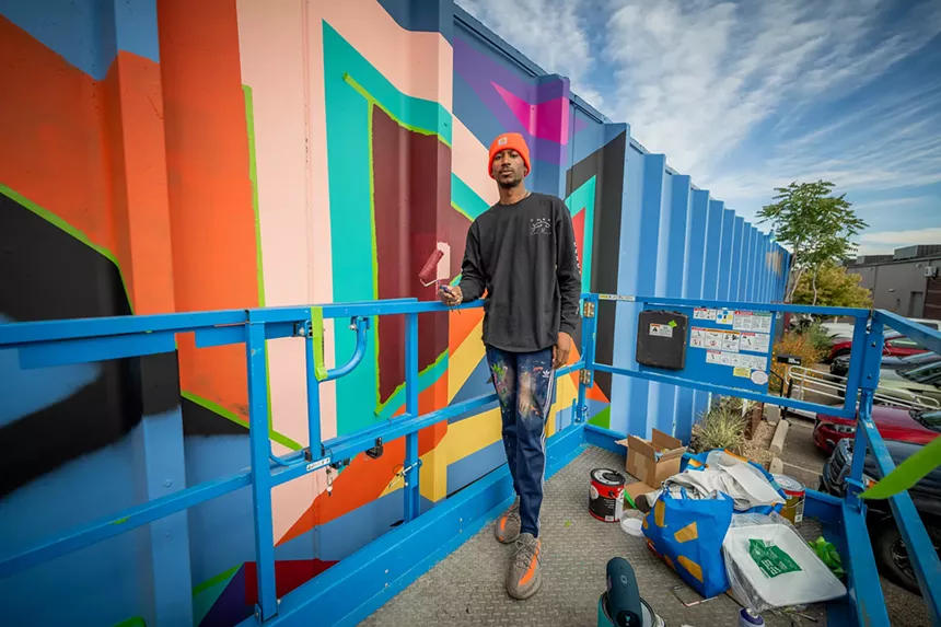 man painting a mural