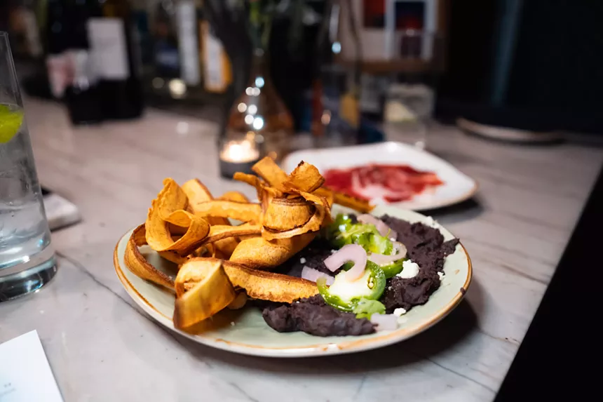 fried platains and black beans on a plate