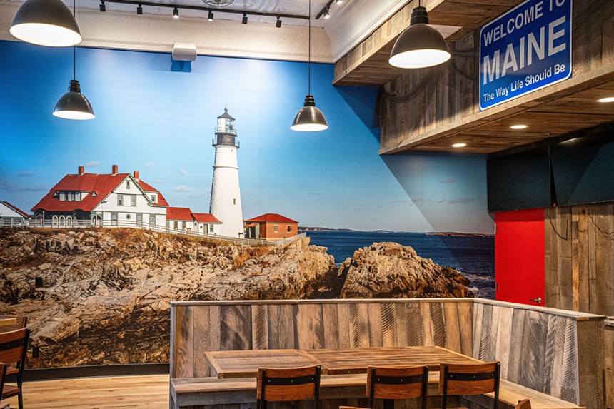 chairs and lighthouse mural with maine sign