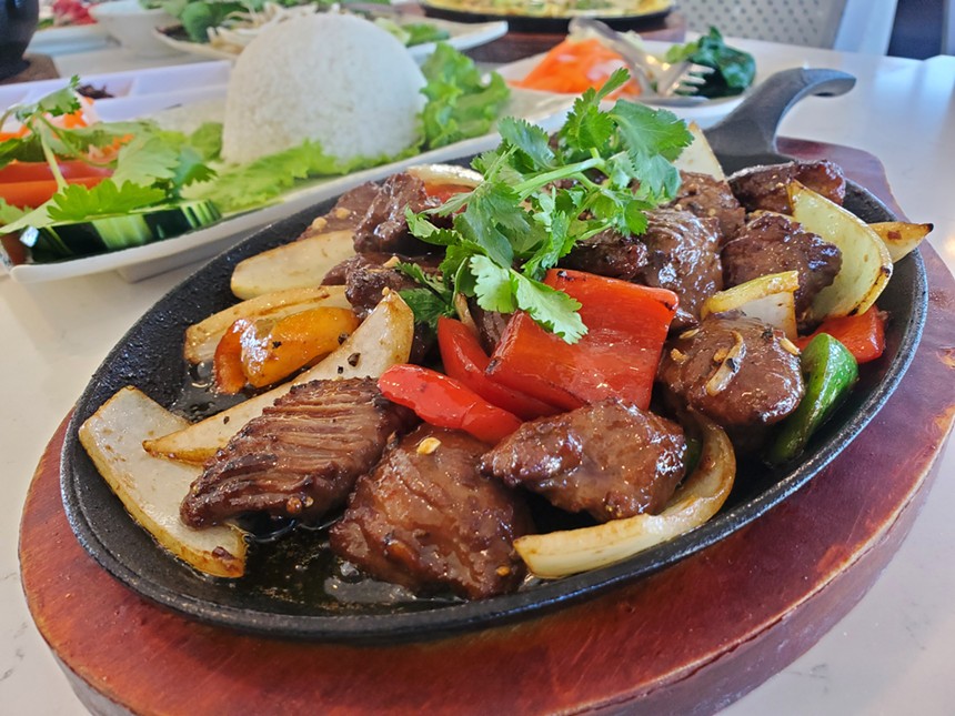 beef and vegetables on a black skillet