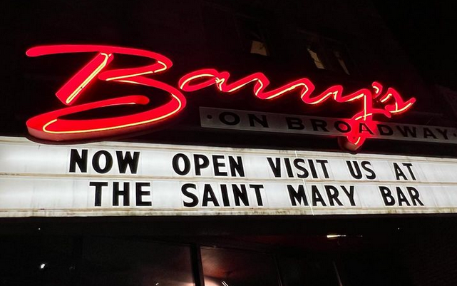 a neon sign with a marquee underneath