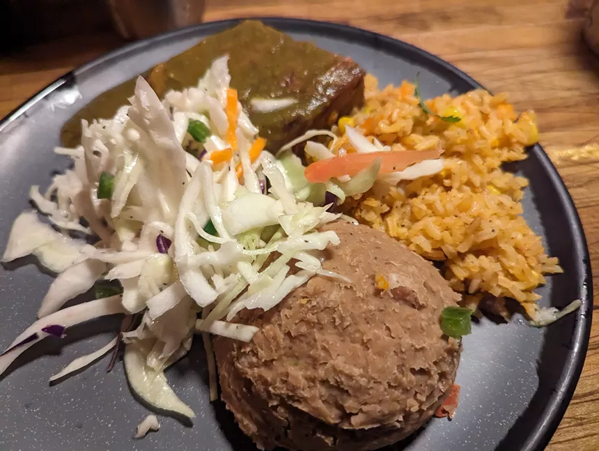 plate of beans, slaw, rice, brisket