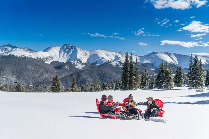 Four people in Adirondack chairs